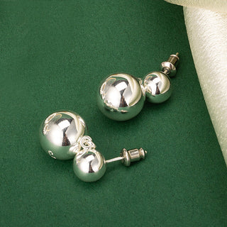 Hoop Earrings with a minimalist statement, featuring double spheres for a simple yet impactful addition to your jewelry collection